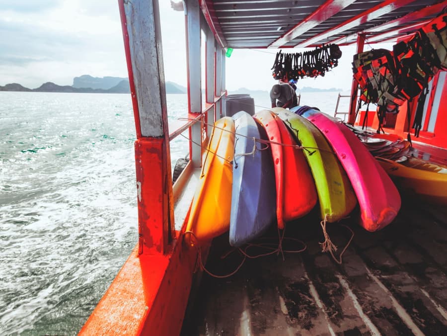 The open cockpit and seat of a kayak resting on grass