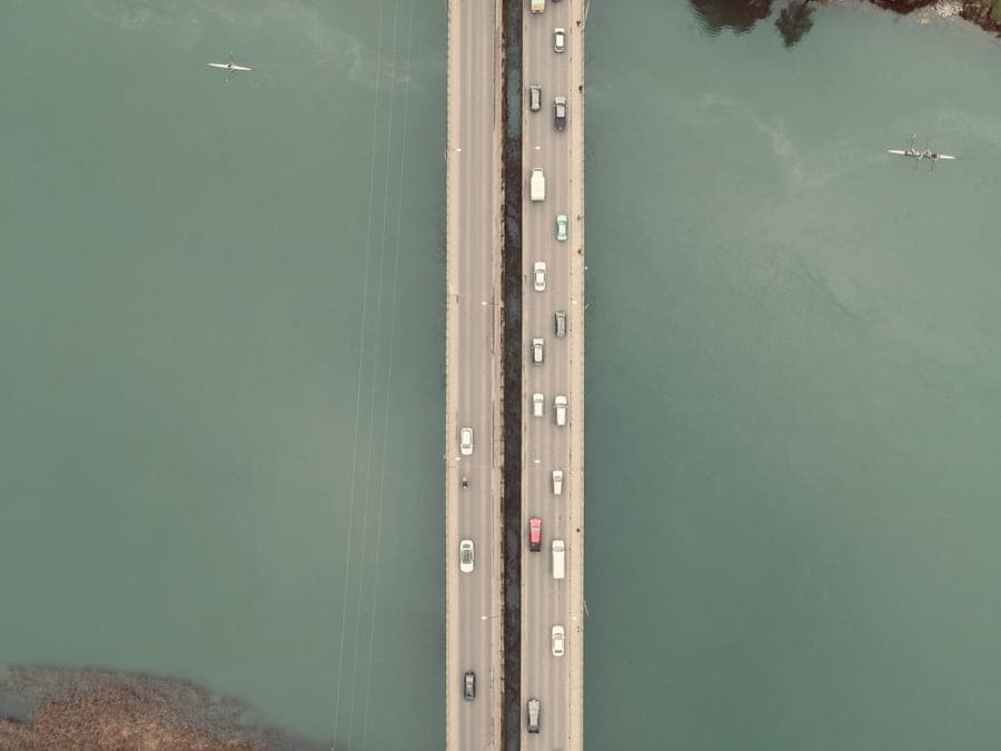 A kayak strapped to the roof of a car on a road